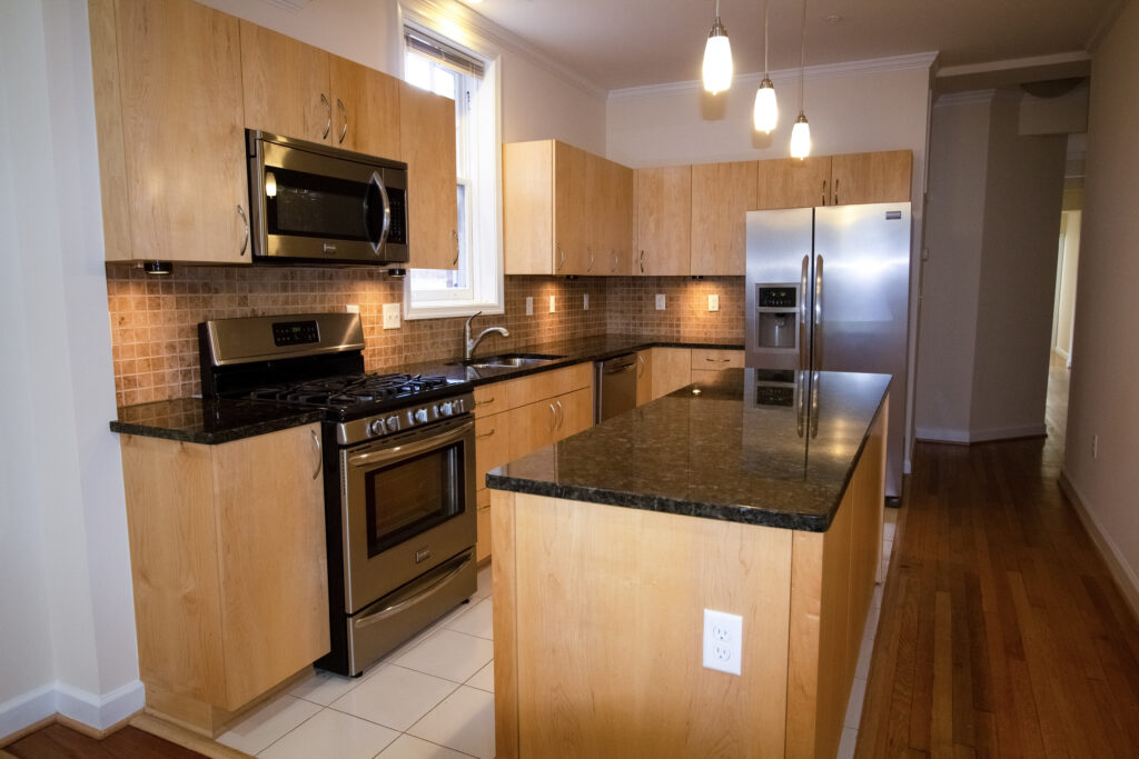 Renovated apartment kitchen with granite counters and stainless appliances