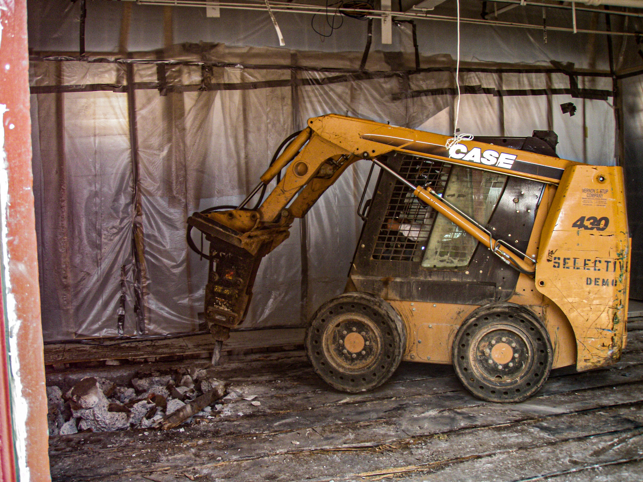 Skid-steer loader carrying out selective interior demolition at the Patrick Maxwell Building