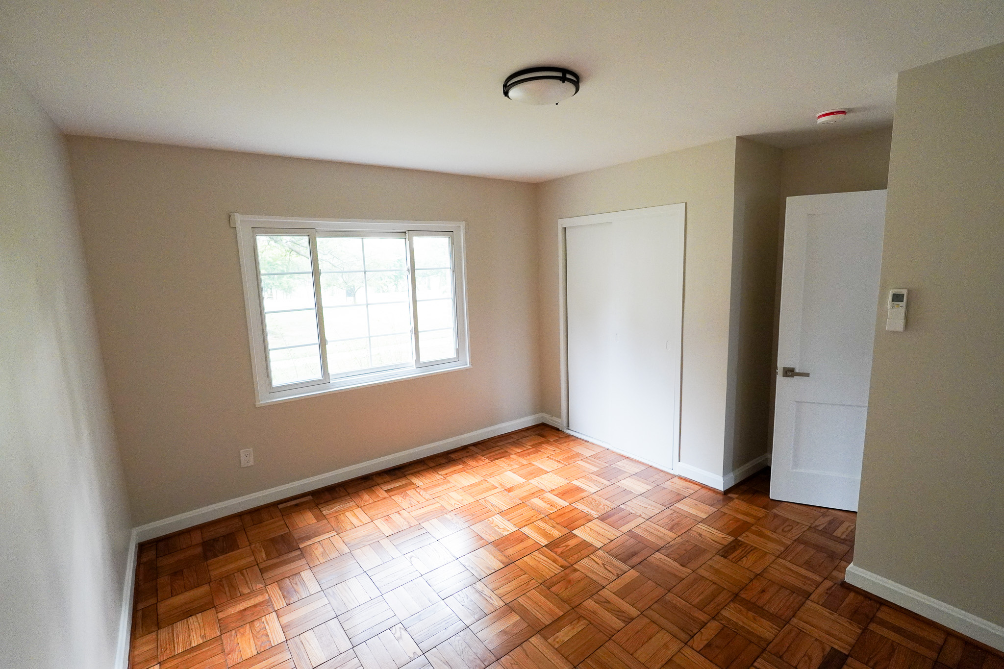 Renovated apartment living room with new flooring and windows at Park View