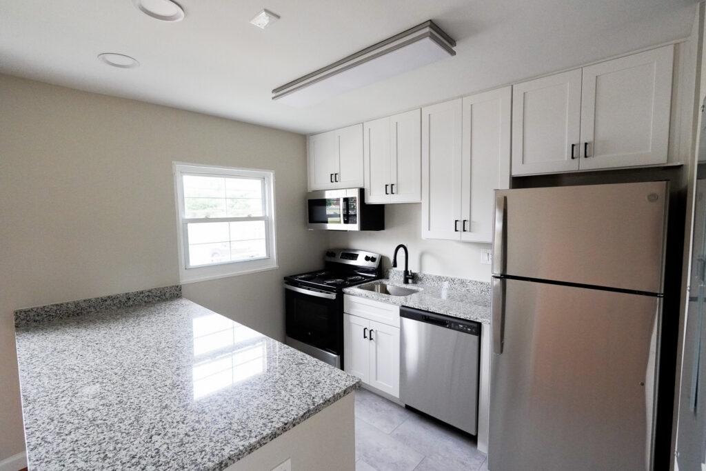 Updated apartment kitchen with stainless refrigerator at Park View