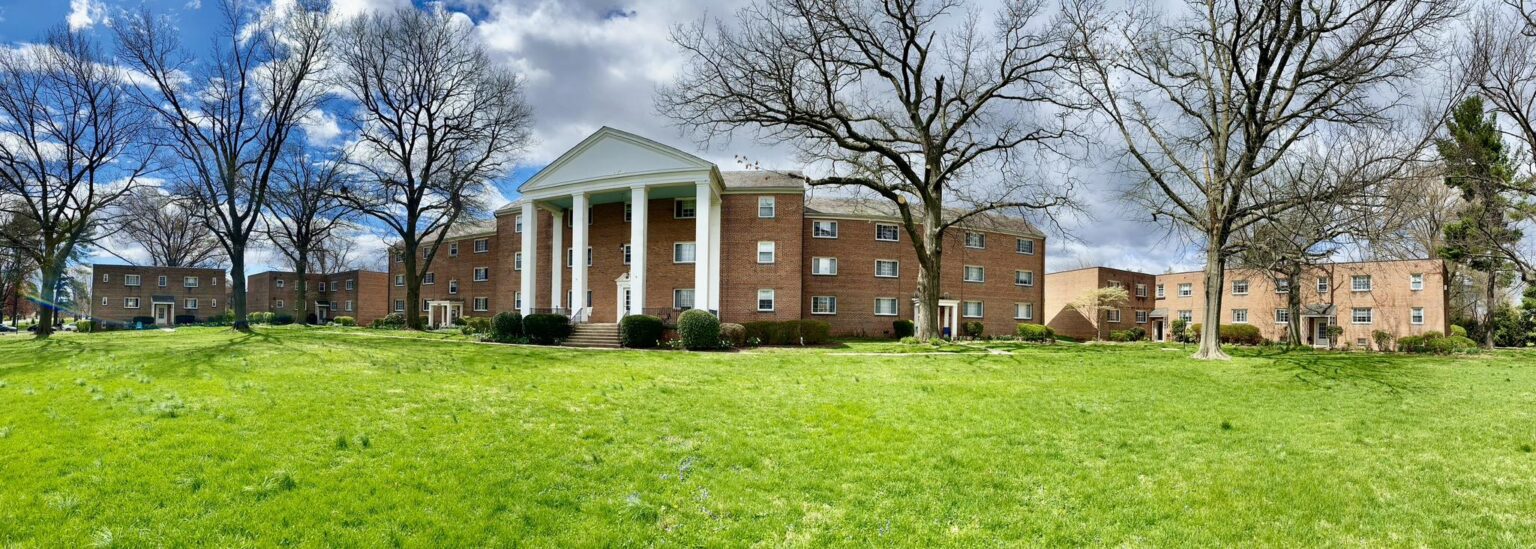 Park View Apartments exterior after renovation, brick building with columned entry
